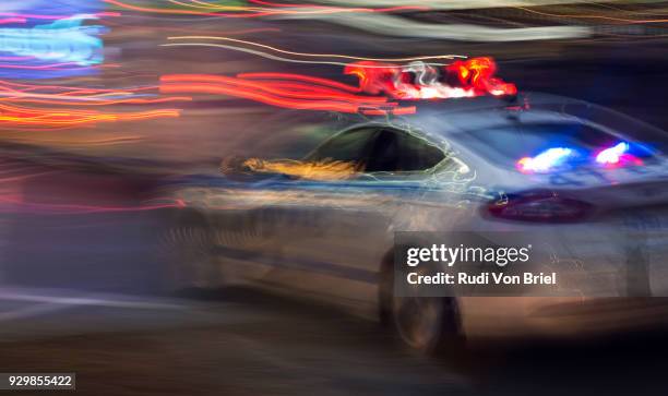 moving police car with flashing lights. - police car lights stock pictures, royalty-free photos & images