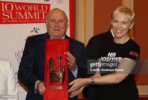 Former South African leader Frederik Willem de Klerk hands over the Peace award to musician Annie Lennox on the second day of the 10th World Summit...