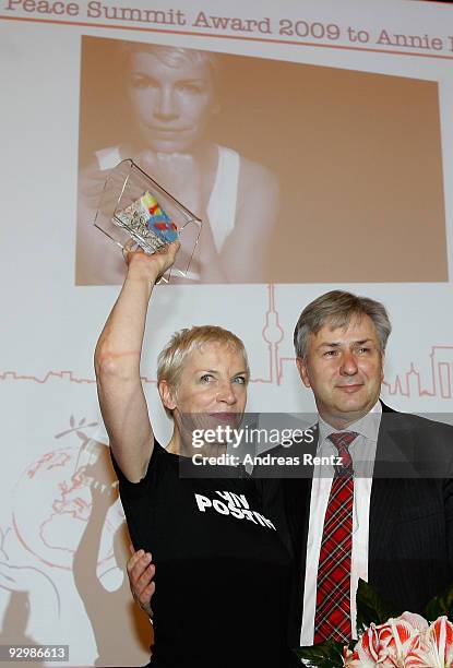 Musician Annie Lennox holds up a piece of the Berlin historical wall, that she get from Berlin's mayor Klaus Wowereit, after she received the Peace...