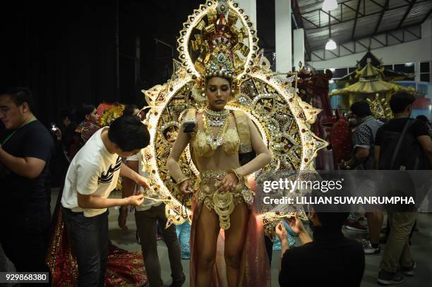 Noel Tokuhisa of Sri Lanka has her elaborate national costume fitted backstage during the Miss International Queen 2018 transgender beauty pageant in...