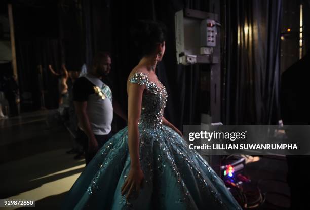 Michel Epalza Betancourt of Venezuela waits backstage in an evening gown during the Miss International Queen 2018 transgender beauty pageant in...