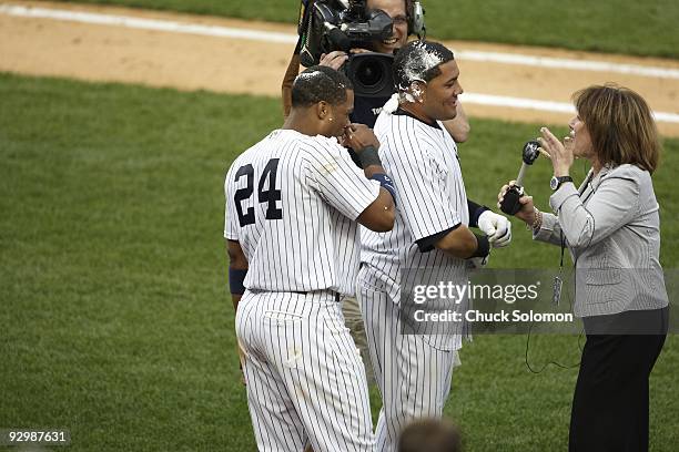 New York Yankees Robinson Cano and Melky Cabrera victorious after getting cream pie in the face with WCBS radio broadcaster Suzyn Waldman after game...