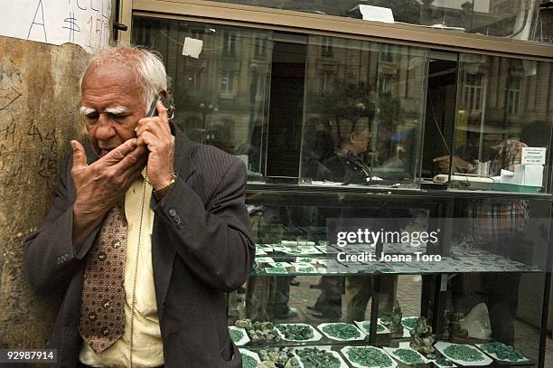 Man discusses the sale of raw emeralds over the phone on August 26, 2009 in Bogota, Cundinamarca, Colombia. Colombia produces 55% of the world's...