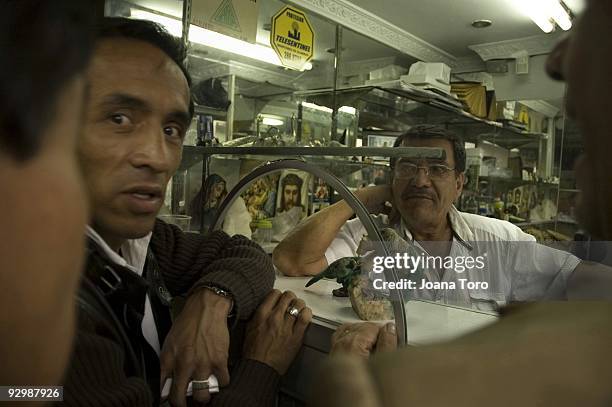 Men discuss the sale of raw emeralds at a retail shop on August 26, 2009 in Bogota, Cundinamarca, Colombia. Colombia produces 55% of the world's...