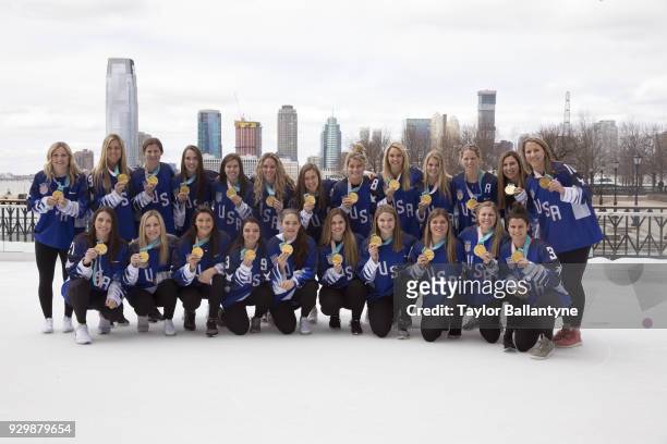 Portrait of Team USA posing for group photo on ice with their gold medals during photo shoot at The Rink at Brookfield Place. USA won Gold at the...