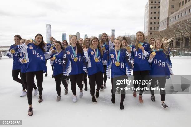 Portrait of Team USA posing for group photo on ice with their gold medals during photo shoot at The Rink at Brookfield Place. USA won Gold at the...