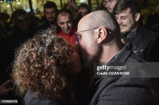 Ahmet Sik kisses his wife Gonca Sik after his release from Silivri prison on March 9, 2018 in Istanbul. An Istanbul court on March 9 ordered the...