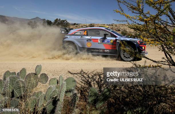 Norwegian driver Andreas Mikkelsen steers his Hyundai I20 Coupe WRC with compatriot co-driver Anders Jaeger-Synnevaag, during the first day of the...