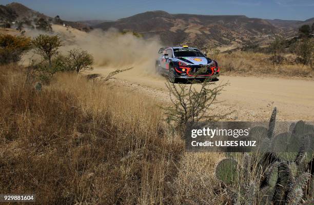 Norwegian driver Andreas Mikkelsen steers his Hyundai I20 Coupe WRC with compatriot co-driver Anders Jaeger-Synnevaag, during the first day of the...