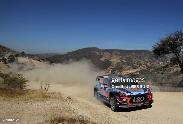 Belgian driver Thierry Neuville steers his Hyundai i20 Coupe WRC with compatriot co-driver Nicolas Gilsoul, during the first day of the 2018 FIA...