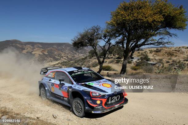 Belgian driver Thierry Neuville steers his Hyundai i20 Coupe WRC with compatriot co-driver Nicolas Gilsoul, during the first day of the 2018 FIA...