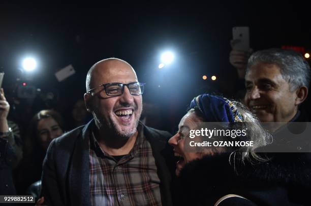 Turkish journalist Ahmet Sik celebrates with friends after being released from Silivri prison on March 10, 2018 in Istanbul. An Istanbul court on...