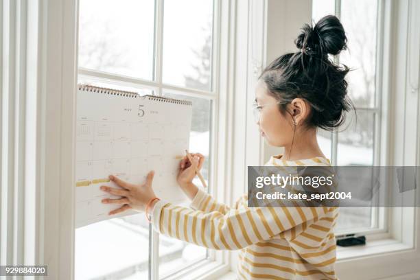 girl with calendar - 2018 calendar stock pictures, royalty-free photos & images