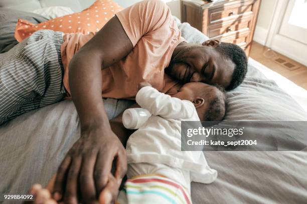 happy father playing with toddler son - baby eating toy stock pictures, royalty-free photos & images