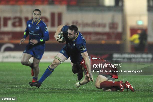 Leinster's Jack Conan is tackled by Scarlets' Jonathan Evans during the Guinness Pro14 Round 17 match between Scarlets and Leinster Rugby at Parc y...