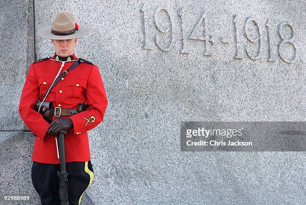 Member of the Royal Canadian Mounte Police stands on the National War Memorial during a Remembrance Day Service on November 11, 2009 in Ottawa,...