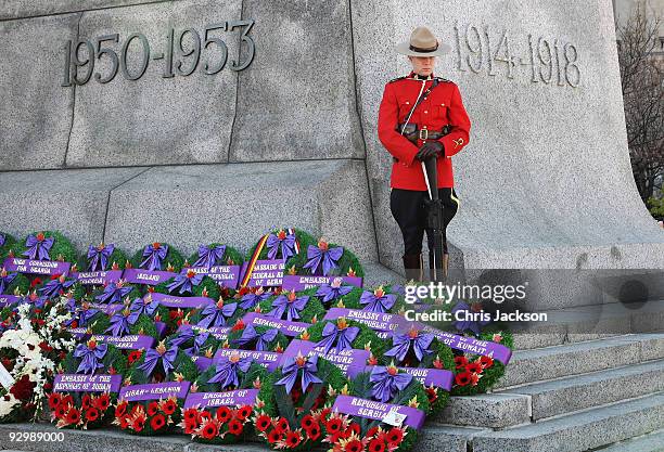 Member of the Royal Canadian Mounte Police stands on the National War Memorial during a Remembrance Day Service on November 11, 2009 in Ottawa,...