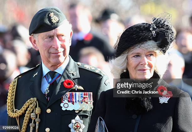 Prince Charles, Prince of Wales and Camilla, Duchess of Cornwall look on as veterans walk past during a Remembrance Day Service at the National War...