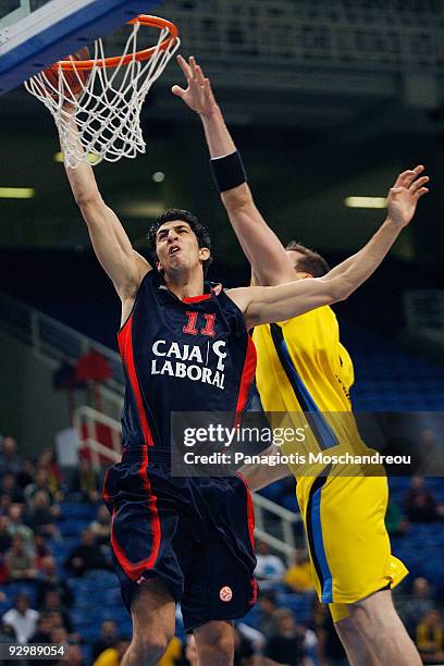 Lior Eliyahu, #11 of Caja Laboral competes with Jared Homan, #9 of Maroussi Costa Coffee during the Euroleague Basketball Regular Season 2009-2010...