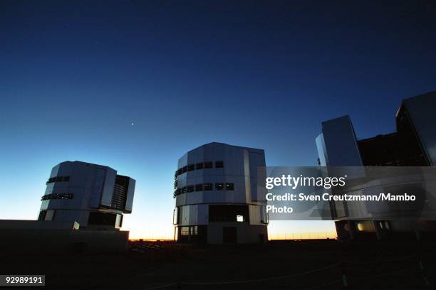 Three of the four telescopes of the Very Large Telescope after sunset over the Atacama desert on October 26 in Paranal, Chile. The VLT Observatory...