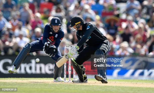 New Zealand batsman Martin Guptill fine cuts for some runs watched by Jos Buttler during the 5th ODI between New Zealand and England at Hagley Oval...
