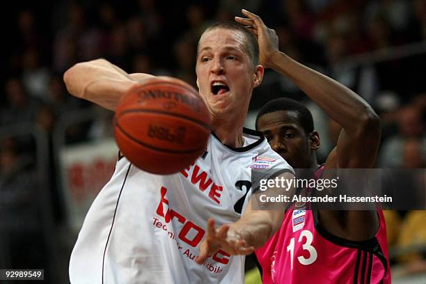 Casey Jacobsen of Bamberg battles for the ball with Patrick Flomo of Bonn during the Basketball Bundesliga match between Brose Baskets Bamberg and...