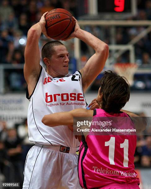 Casey Jacobsen of Bamberg battles for the ball with Artur Kolodziejski of Bonn during the Basketball Bundesliga match between Brose Baskets Bamberg...