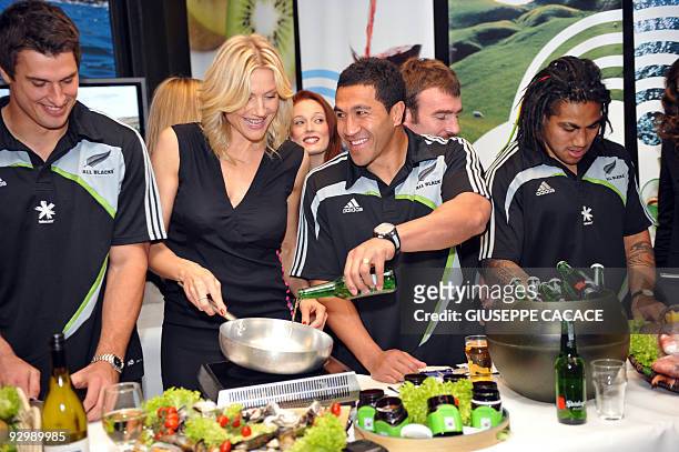 New Zealands All Black rugby players Ma'a Nonu , Mils Muliaina , Russian model and TV presenter Natasha Stefanenko and Anthony Boric pose during a...