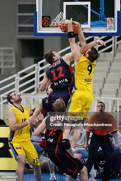 Mirza Teletovic, #12 of Caja Laboral competes with Jared Homan, #9 of Maroussi Costa Coffee during the Euroleague Basketball Regular Season 2009-2010...