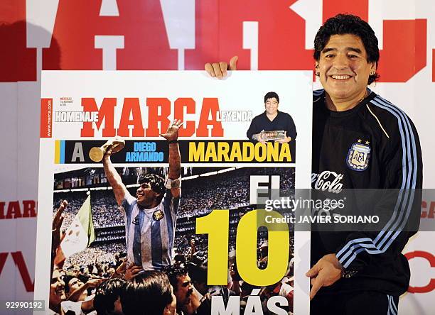 Coach of the Argentinian football team Diego Armando Maradona poses with a giant replica of the newspaper Marca after Argentinian football player...