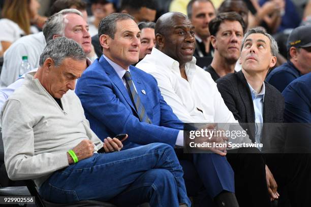 Pac-12 Commissioner Larry Scott sits next to Los Angeles Lakers President of Basketball Operations Magic Johnson during the quarterfinal game of the...