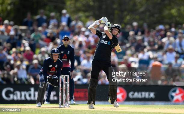 New Zealand batsman Mitchell Santner hits Moeen Ali for 6 during the 5th ODI between New Zealand and England at Hagley Oval on March 10, 2018 in...