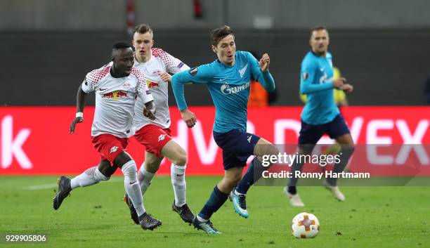 Daler Kuzyaev of FC Zenit Saint Petersburg, Lukas Klostermann and Naby Keita of RB Leipzig compete during the UEFA Europa League Round of 16 match...