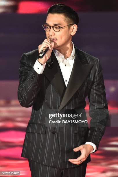 This picture taken on March 9, 2018 shows musician Afgansyah Reza performing during the finals of the 2018 Miss Indonesia beauty pageant in Jakarta....