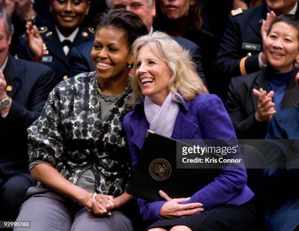 First lady Michelle Obama and Doctor Jill Biden, wife of U.S. Vice President Joe Biden, laugh as a Alma Powell speaks during the ServiceNation launch...
