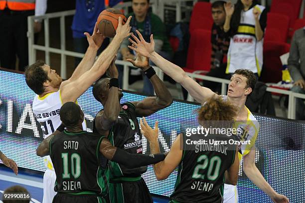 Oguz Savas, #21 of Fenerbahce Ulker competes with and Omer Asik, #24 of Fenerbahce Ulker competes with and Benjamin Eze, #8 of Montepaschi Siena...