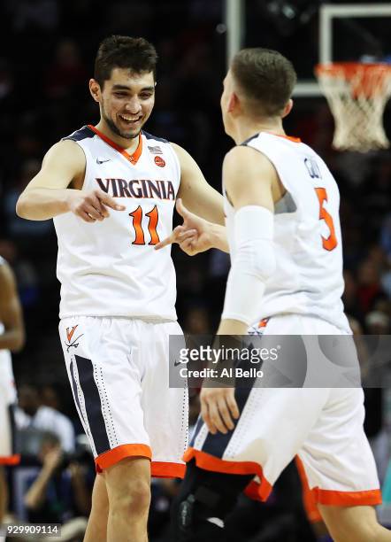 Ty Jerome of the Virginia Cavaliers and Kyle Guy celebrate a basket against the Clemson Tigers during the semifinals of the ACC Men's Basketball...