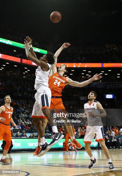 De'Andre Hunter of the Virginia Cavaliers and David Skara of the Clemson Tigers battle for the ball during the semifinals of the ACC Men's Basketball...