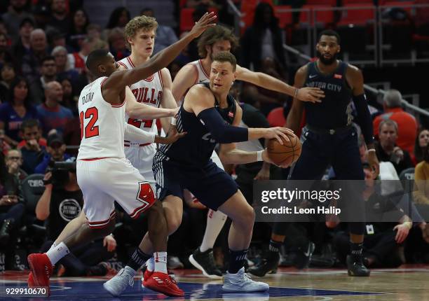 Blake Griffin of the Detroit Pistons looks to make a pass as Kris Dunn of the Chicago Bulls defends during the first half of the game at Little...