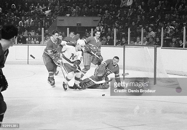 S - Andre Boudrias of the Minnesota North Stars attempts to score a goal against Lorne "Gump" Worsley of the Montreal Canadiens while Terrance...