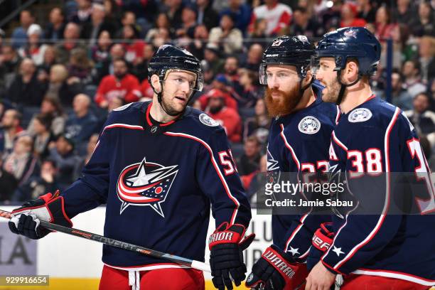 Mark Letestu, Ian Cole and Boone Jenner of the Columbus Blue Jackets talk prior to a face-off during the second period of a game against the Detroit...