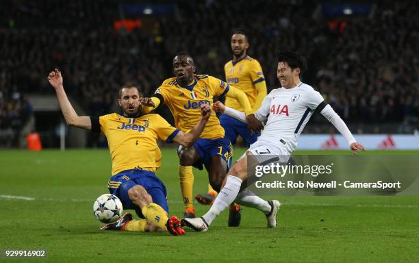 Tottenham Hotspur's Son Heung-Min is challenged by Giorgio Chiellini and Blaise Matuidi of Juventus during the UEFA Champions League Round of 16...