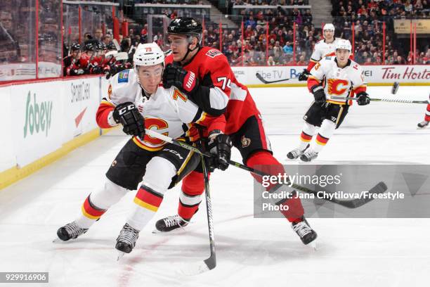 Mark Borowiecki of the Ottawa Senators battles for position against Micheal Ferland of the Calgary Flames in the first period at Canadian Tire Centre...