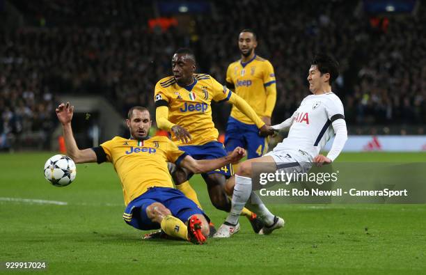 Tottenham Hotspur's Son Heung-Min is challenged by Giorgio Chiellini and Blaise Matuidi of Juventus during the UEFA Champions League Round of 16...