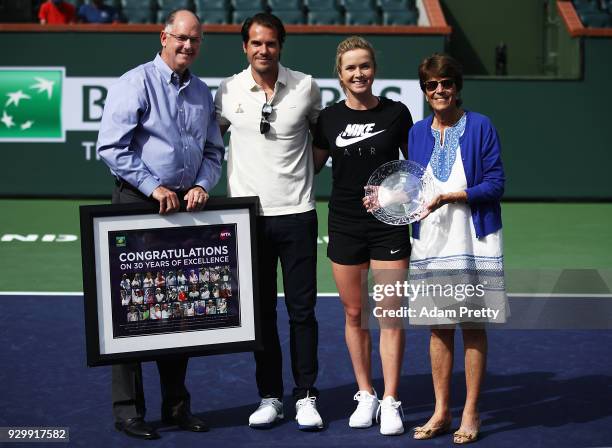 Steve Simon CEO of the WTA and Elina Svitolina of the Ukraine present BNP Paribas Open Tournament Director Tommy Haas and Peggy Michel with an award...