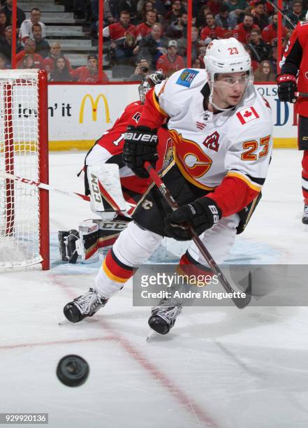 Sean Monahan of the Calgary Flames skates for a loose puck against the Ottawa Senators at Canadian Tire Centre on March 9, 2018 in Ottawa, Ontario,...