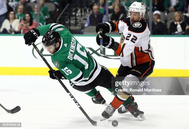 Jason Dickinson of the Dallas Stars skates the puck against Chris Kelly of the Anaheim Ducks during the first period at American Airlines Center on...