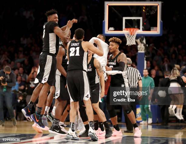 The Providence Friars celebrate the 75-72 overtime win over the Xavier Musketeers during semifinals of the Big East Basketball Tournament at Madison...