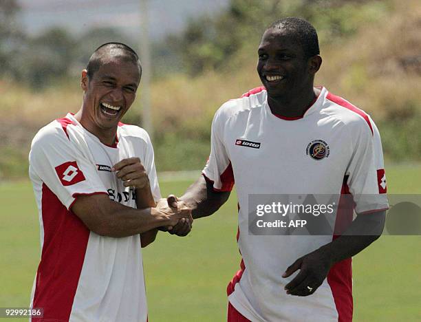 Costa Rican footballers Gilberto Martinez and Froylan Ledezma joke after a training session in the province of Alajuela, some 20 km west from San...