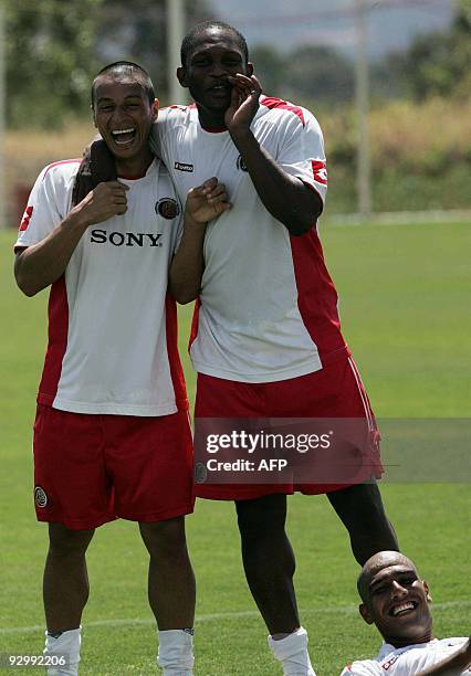 Costa Rican footballers Gilberto Martinez , Froylan Ledezma and Douglas Sequeira joke after a training session in the province of Alajuela, some 20...